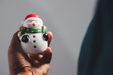 Businessman in hand with Santa Claus smiling with snowman christmas celebration concept

