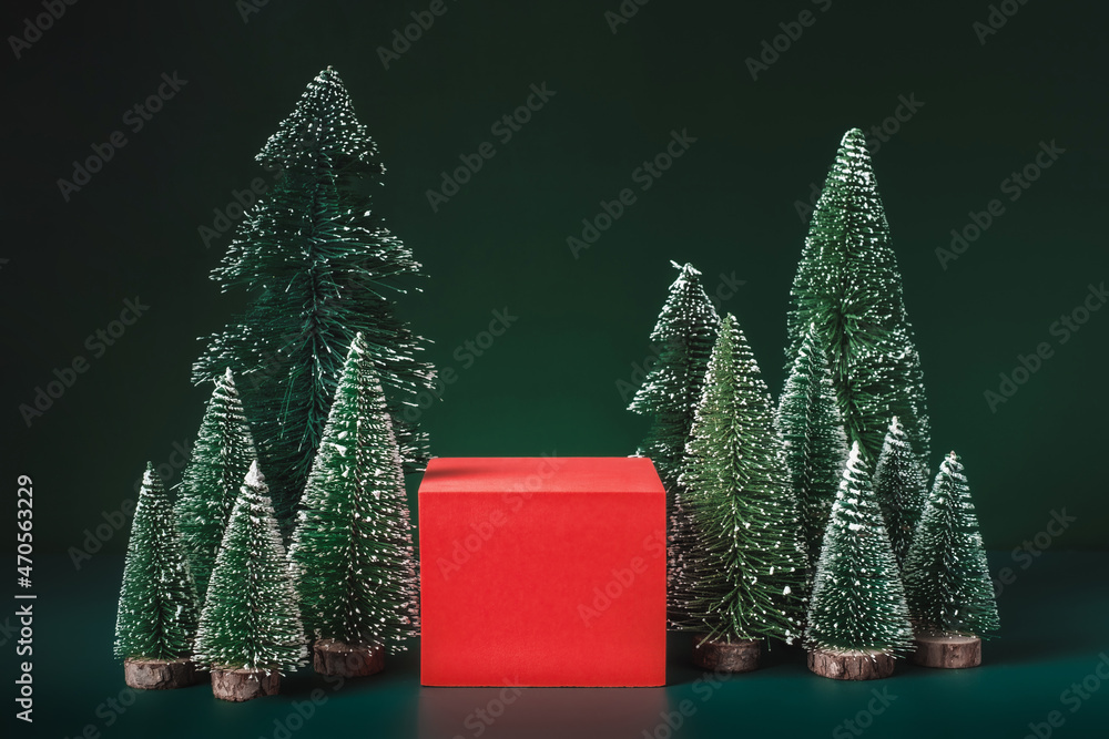 Poster christmas tree group and red vivid product display block on green background.