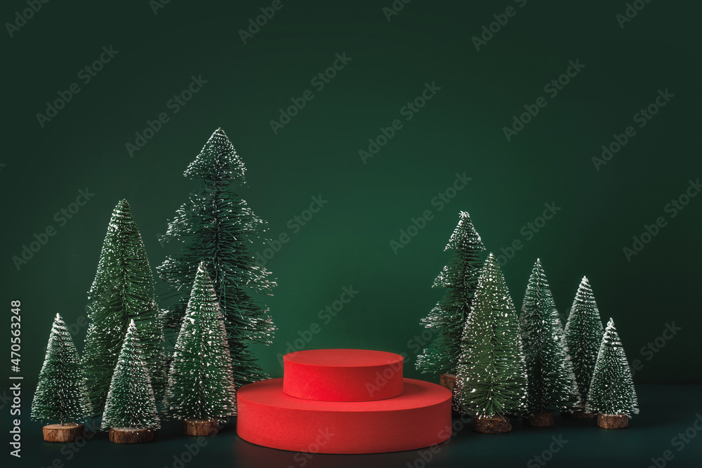 Poster christmas tree group and red vivid product display block on green background.