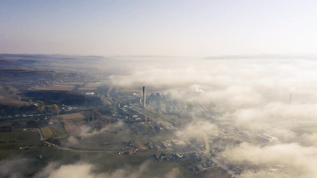 Aerial view of industrial zone covered with autumn fog in Dej, Romania.