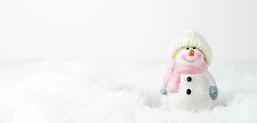 Christmas background. Happy snowman standing in winter snowy Christmas landscape. Merry christmas and happy new year greeting card. Funny snowman in a hat on a snowy background. Banner.