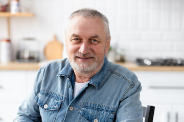 Fototapeta premium Portrait of happy senior man looking at camera