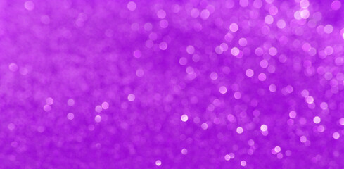 Violet, lilac, purple Christmas background with defocused lights. Background for Valentine's Day. White or silver lights on a Violet background.