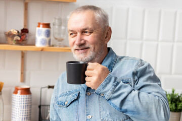 Portrait of happy senior man with cup of coffee