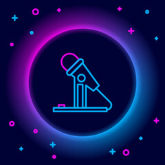 Glowing neon line Microphone icon isolated on black background. On air radio mic microphone. Speaker sign. Colorful outline concept. Vector
