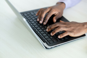 Online search. Working man. Digital world network. Unrecognizable male hands fast typing on laptop on light desk.