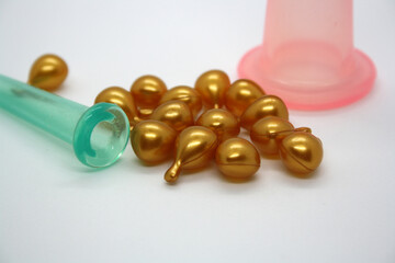 A jar for facial massage and gold capsules with oil.