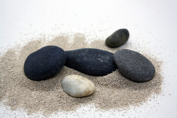 Obraz na płótnie Canvas Sea round stones on the fine sand. Selective focus.