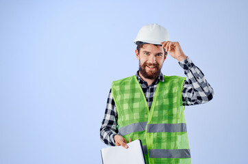 male builder with documents and drawings blueprints blue background