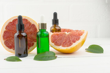 three cosmetic flaons with grapefruit oil for beauty, skin care, well-being. alternative medicine.