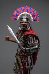 Screaming roman soldier dressed in steel armor and plumed helmet