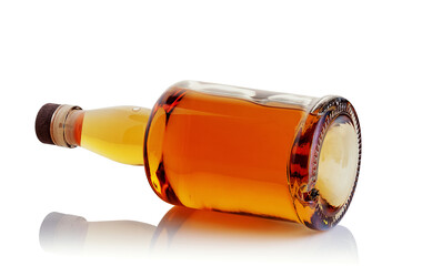 A bottle of whiskey on a glossy white background