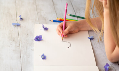 Child drawing on a paper, art 