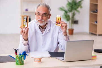 Old male dentist in time management concept