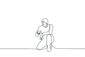 man knelt on one knee to the ground, water flows out of his hand, he looks at it - one line drawing vector. concept of finding water source, geologist or ecologist on marshland, pollution of water bod
