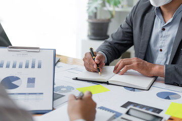 Business people working together brainstorm ideas analyze financial report at office.