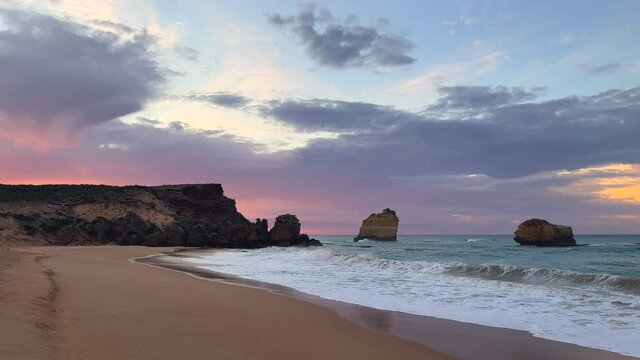 Looking along coast at beautiful coloured sky with rock formations at The 12 Apostles