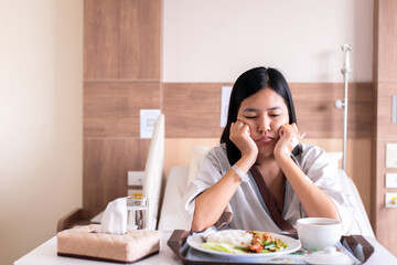 Asian patient women feeling unhappy and bored meal,Loss of appetite,Bored with food