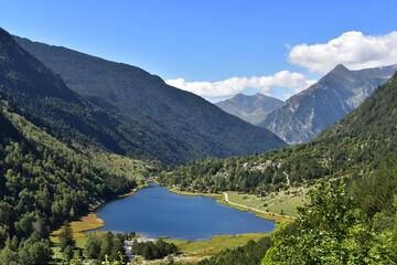 Naklejka na ściany i meble Beautiful mountains,blue lake,green valley,forest.Bright breathtaking,thrilling view in summer,spring,sunny weather.Aiguestortes national park,Spain,Pyrenees