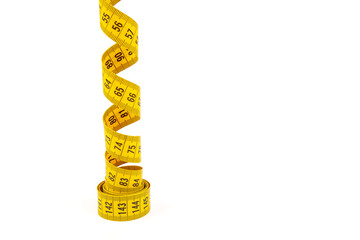 Yellow measuring tape spiral, isolated on white background.