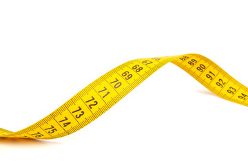 Yellow measuring tape spiral, isolated on white background.