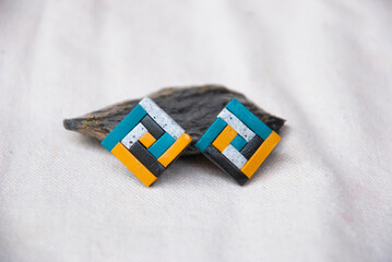 Handmade jewelry background. Unique earrings in geometric style.