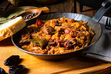 Polish bigos cooked according to an old recipe with wine and plum