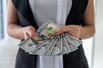 young business woman with us dollar money in hand stand at office