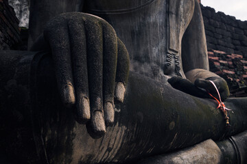 statue of buddha temple hand prying in thailand Sukhothai