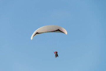 Twin paraglider. Paragliding against the blue sky.