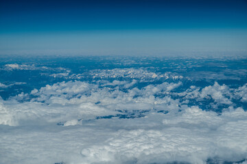 Naklejka premium White heavy clouds in the blue sky. Panoramic cloudscape above the clouds.