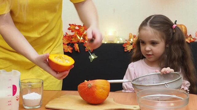 Mam And Daughter Are Making Dough pie For Thanksgiving Pie. put the dough in a mold for a thanksgiving pumpkin pie. Process of making Pumpkin pie for Thanksgiving Day. Seasonal traditional autumn fest