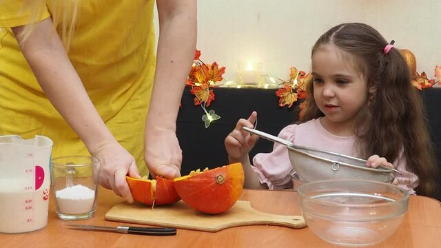 Mam And Daughter Are Making Dough pie For Thanksgiving Pie. put the dough in a mold for a thanksgiving pumpkin pie. Process of making Pumpkin pie for Thanksgiving Day. Seasonal traditional autumn fest