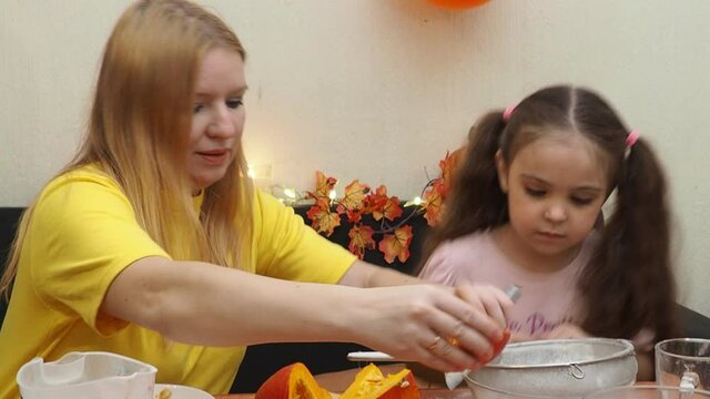 Mam And Daughter Are Making Dough pie For Thanksgiving Pie. put the dough in a mold for a thanksgiving pumpkin pie. Process of making Pumpkin pie for Thanksgiving Day. Seasonal traditional autumn fest