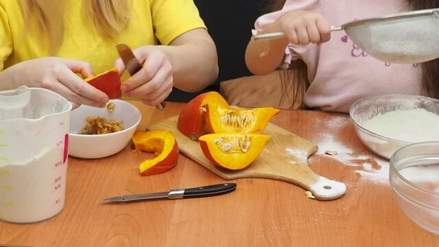 Mam And Daughter Are Making Dough pie For Thanksgiving Pie. put the dough in a mold for a thanksgiving pumpkin pie. Process of making Pumpkin pie for Thanksgiving Day. Seasonal traditional autumn fest