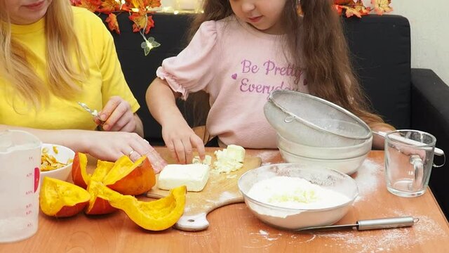 Mam And Daughter Are Making Dough pie For Thanksgiving Pie. put the dough in a mold for a thanksgiving pumpkin pie. Process of making Pumpkin pie for Thanksgiving Day. Seasonal traditional autumn fest