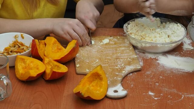 Mam And Daughter Are Making Dough pie For Thanksgiving Pie. put the dough in a mold for a thanksgiving pumpkin pie. Process of making Pumpkin pie for Thanksgiving Day. Seasonal traditional autumn fest