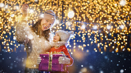 happy mother and daughter decorate together to celebrate the snowfall