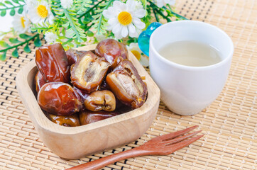 Dried dates fruit in wooden bowl