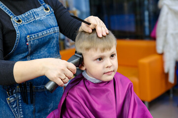 Children's hairdresser. A child with a haircut in a children's hairdressing salon.