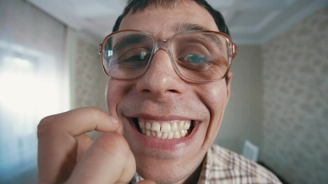 Nerd shows his teeth to the camera