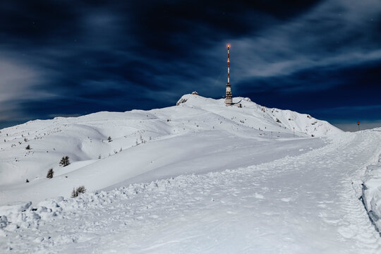 Radio tower Dobratsch on snowcapped mountain at Villach, Carinthia, Austria