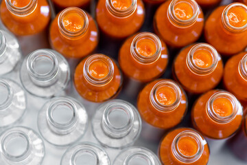 Chili sauce bottles arranged side by side in production factory