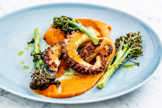 Garnished octopus served in plate on table