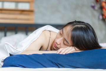 Close up portrait of young beautiful woman lying in sofa, Young woman lying on white sheets in the bedroom in the early morning, Sexy morning concepts