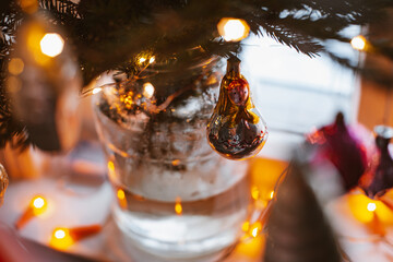 Naklejka premium Christmas rustic old window at night with decorated spruce branches in a glass jar retro decorations