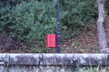 Trash can fixed to the flagpole