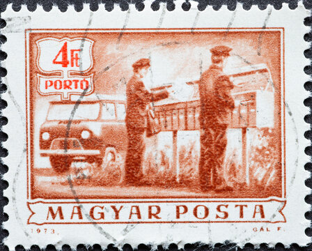 HUNGARY - CIRCA 1973: A Post Stamp Printed In Hungary Showing Two Postal Workers With Delivery Trucks. Postage Due - Rural Mail Delivery