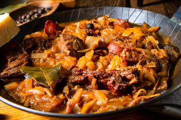 Polish bigos cooked according to an old recipe with wine and plum