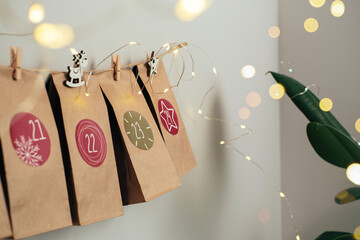 Handmade Christmas advent hanging on the wall, eco style festive decoration, surprise for every day...